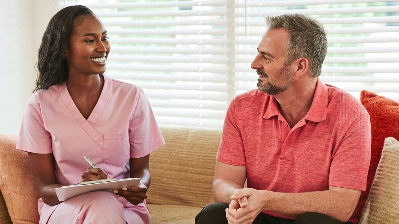 A Comfortlink nurse taking referral details with a client